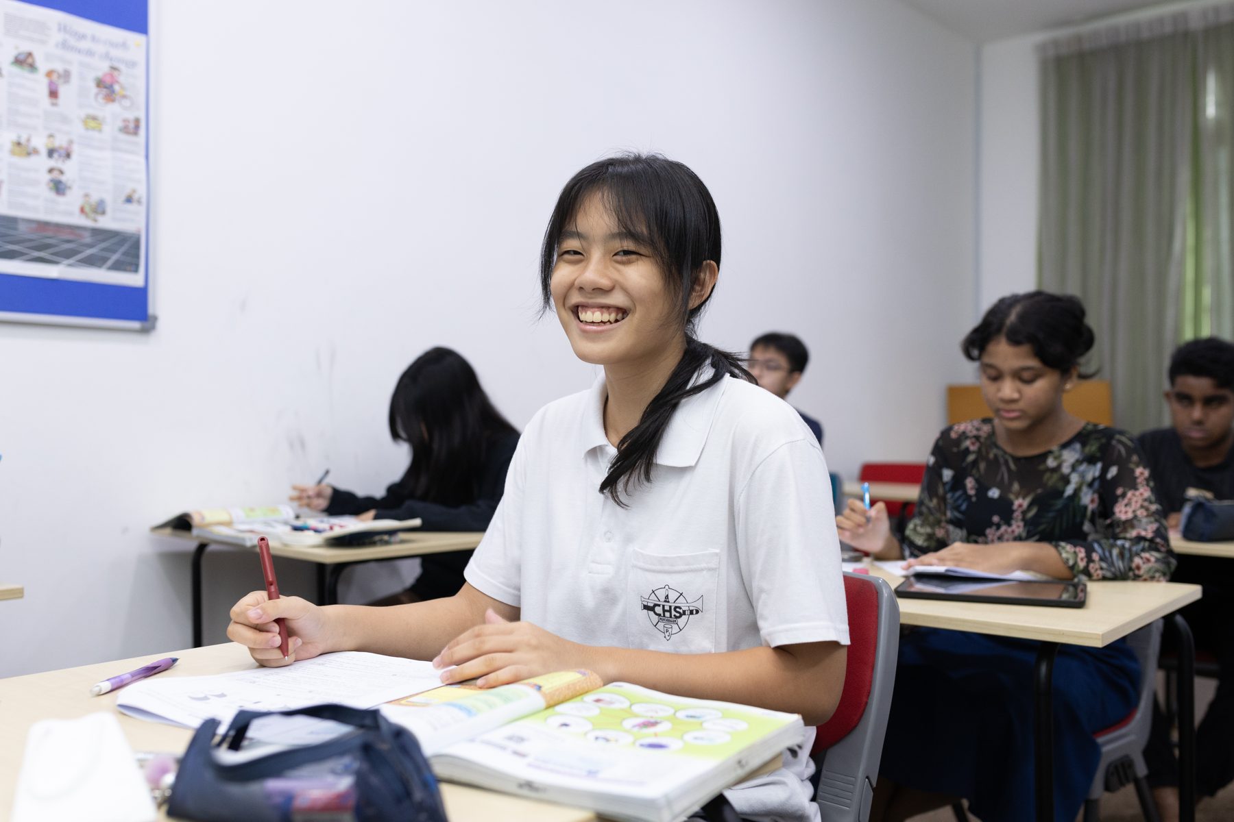 A smiling student learning happily at her own pace at Epic Smart Academy